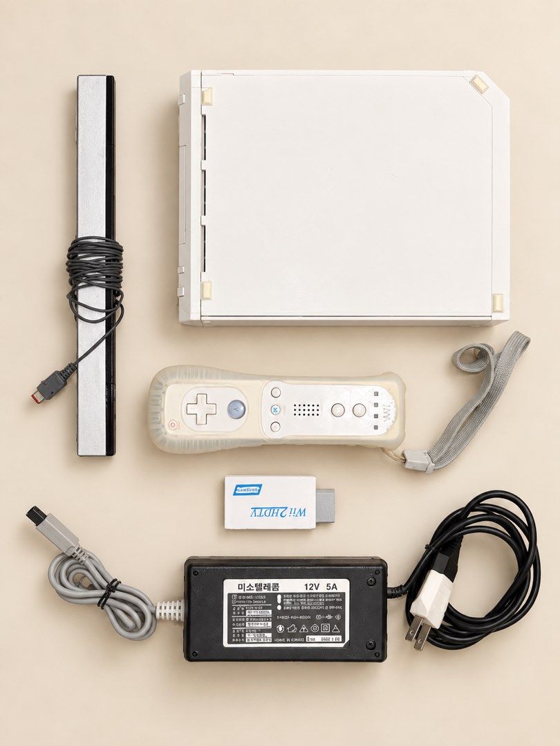 Nintendo Wii Console RVL-001 with Controller and Accessories (Category: Nintendo) located in Quezon City. Submitted by ShopNShip (Listing ID 1466880335, Image 1). Description: Nintendo Wii white console, model RVL-001. Serial number LJF114320377. Includes one remote controller with silicone sleeve and wrist strap. Sensor bar, power supply unit, and Wii2HDMI adapter included. All cords bundled together neatly. Ready for setup and gaming..