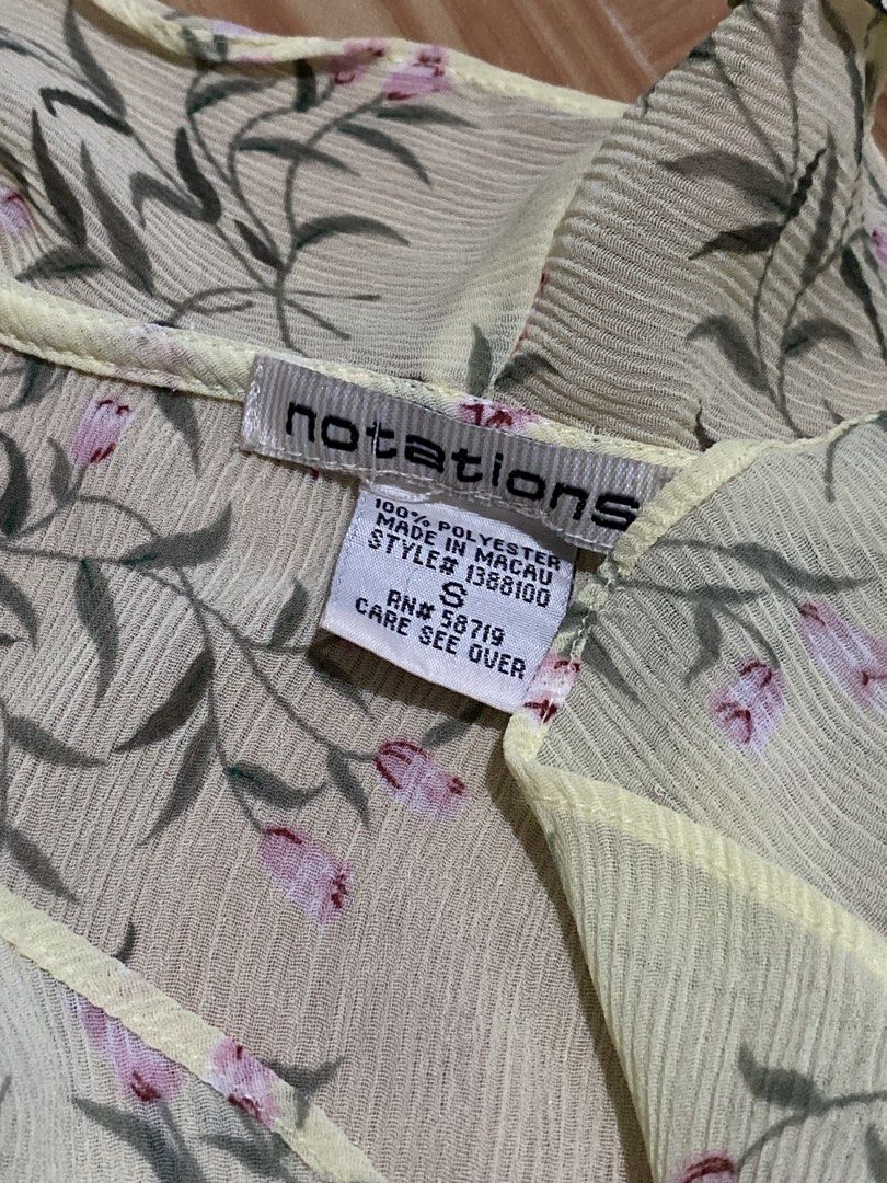Notations Floral Ruffle Blouse Yellow Size S (Category: Blouses) located in Manila. Submitted by zapitup (Listing ID 1466966967, Image 2). Description: - Brand: Notations - Size: Small - Material: 100% polyester (lightweight sheer with crinkled texture) - Design: Yellow with green and pink floral print, ruffled front and cuffs - Condition: Great pre-loved condition - Versatile: Perfect for office wear or casual outings - Made in Macau.