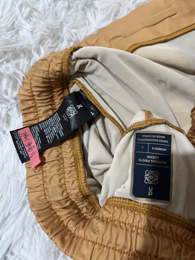 On x Loewe Running Pants (Category: Joggers) located in Caloocan City. Submitted by safewind.d918ef (Listing ID 1466924031, Image 2). Description: On x Loewe running pants in yellow and brown ombre tone. Women size large. Swiss engineering. Elastic waistband with adjustable black drawstring. Zip pocket on the side. Unique panel design and layered details down the legs. Fabric tags and interior branding clearly attached. Great athletic piece with 