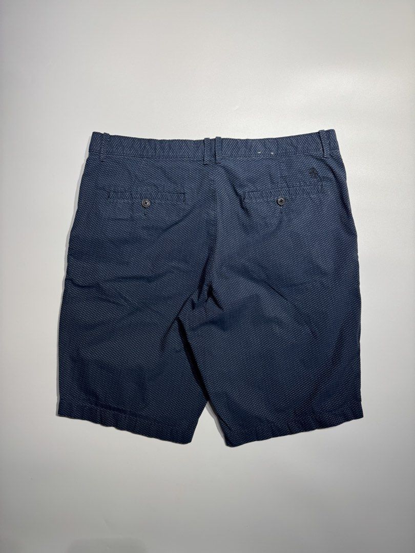 Original Penguin Blue Patterned Shorts (Category: Shorts) located in Cavite. Submitted by dracokidstuff (Listing ID 1466873189, Image 2). Description: - Brand: Original Penguin - Color: Dark Blue with textured geometric pattern - Measurements: 17 inches across waist, 21 inches outseam length - Closure: Button closure and zip fly - Pockets: Front hand pockets and two buttoned rear pockets - Details: Stylish patterned fabric lining along the interi