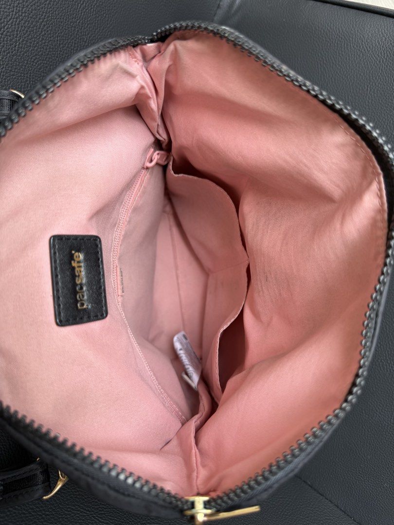 Pacsafe Bag (Category: Cross-body Bags) located in Pasig City. Submitted by may_kca23 (Listing ID 1466962960, Image 3). Description: FOR SALE: Pacsafe Bag 🖤 | Pre-loved 💰 Price: ₱2,200 negotiable Selling my authentic Pacsafe bag in black with pink interior lining and gold-tone hardware. ✨ Details: * Pre-loved / used condition * Spacious interior with multiple compartments * Stylish black design, perfect for everyday use or travel * With visible