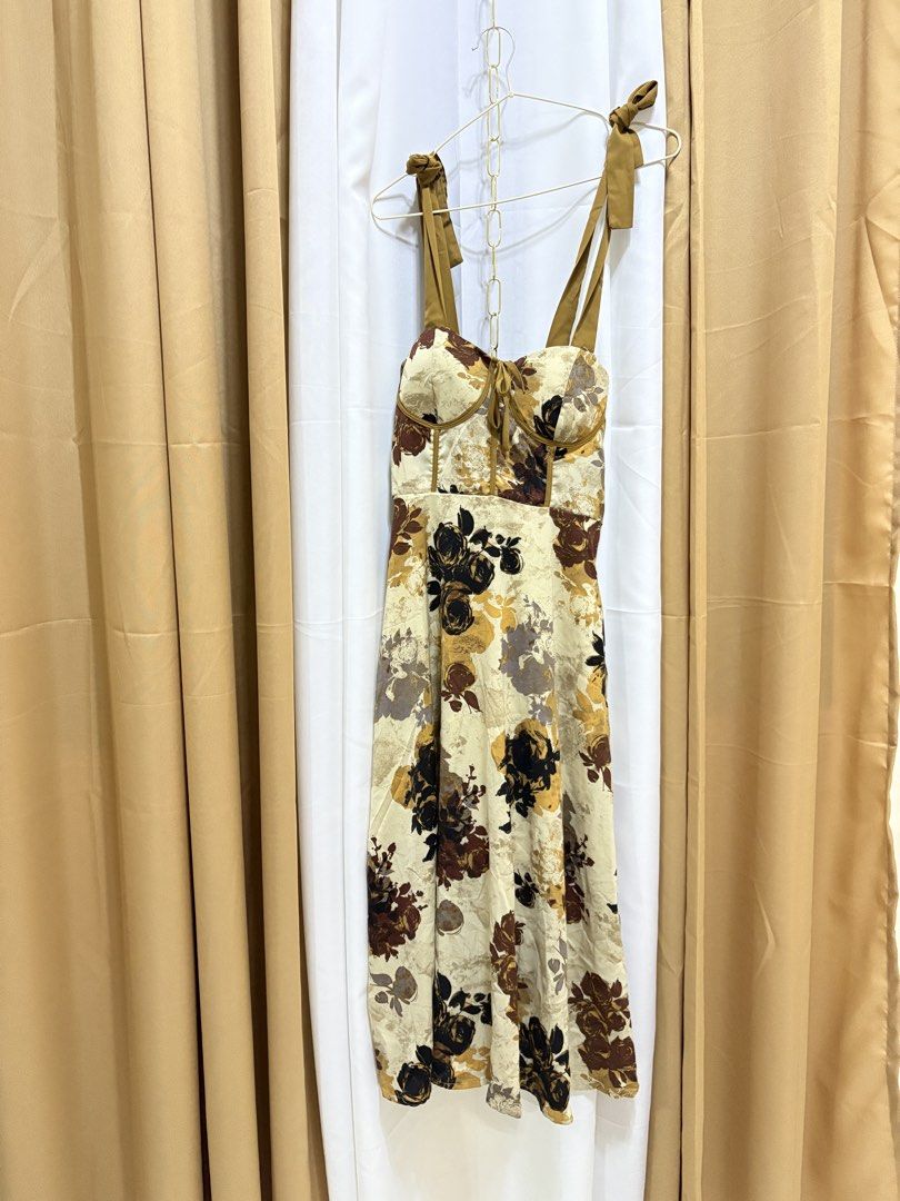 Padded Dress from BKK (Category: Dresses) located in Malolos. Submitted by deffnotandwie (Listing ID 1466898020, Image 1). Description: - Style: Vintage-inspired floral midi dress - Color: Cream with brown, black, and mustard print - Straps: Thick mustard straps with cute bow ties - Fit: Smocked elastic back panel for extra comfort.