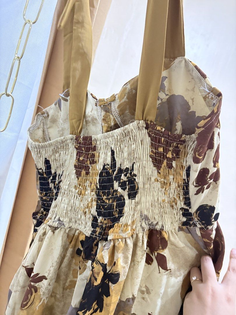 Padded Dress from BKK (Category: Dresses) located in Malolos. Submitted by deffnotandwie (Listing ID 1466898020, Image 3). Description: - Style: Vintage-inspired floral midi dress - Color: Cream with brown, black, and mustard print - Straps: Thick mustard straps with cute bow ties - Fit: Smocked elastic back panel for extra comfort.