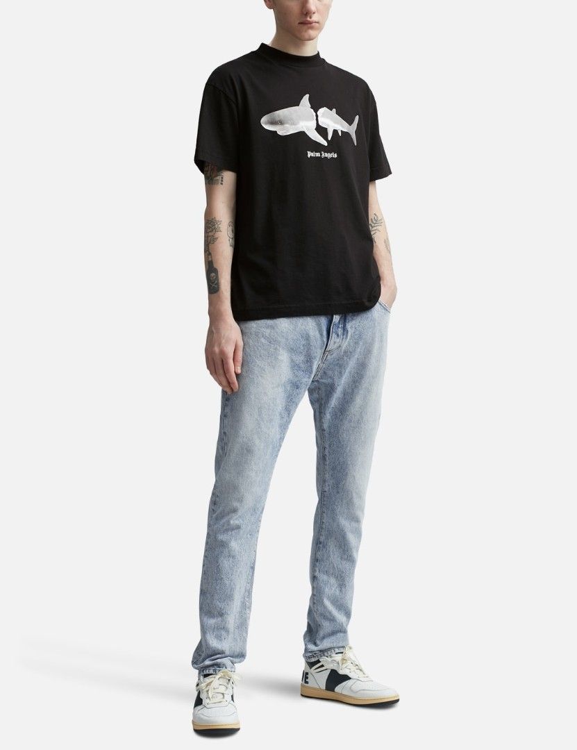Palm Angels Shark Graphic Black Tee (Category: Tshirts & Polo Shirts ) located in San Francisco. Submitted by Intaw20 (Listing ID 1466935786, Image 1). Description: -Dimes 21 x 29 - Palm Angels black t-shirt -Authentication not Guaranteed - Split shark graphic with small white text logo on the chest - Large white gothic arched lettering printed across the back - Classic ribbed crew neck collar and short sleeves - Clean fabric with crisp, crack-fr