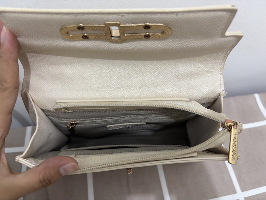 Parisian Cream Top Handle Handbag (Category: Shoulder Bags) located in Los Banos. Submitted by _bugsssbunny (Listing ID 1466877368, Image 2). Description: Cream textured handbag from Parisian with gold-tone hardware and clasp closure. Includes a top handle plus an adjustable leather and chain shoulder strap. Interior has zippered pocket to keep items organized. Clean fabric lining inside..