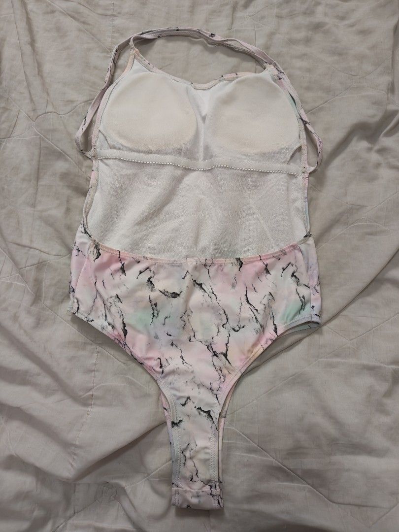 Pastel marble Halter one-piece swimsuit (Category: Bikinis & Swimsuits) located in Antipolo. Submitted by _suspiria (Listing ID 1466778860, Image 2). Description: - Style: Halter neck one-piece swimsuit with thin straps - Design: Trendy high-cut leg and colorful pastel marble pattern - Details: Soft material featuring unique black vein accents mixed with pink, yellow, and green tones - Occasion: Ideal for beach getaways, pool parties, and vacatio