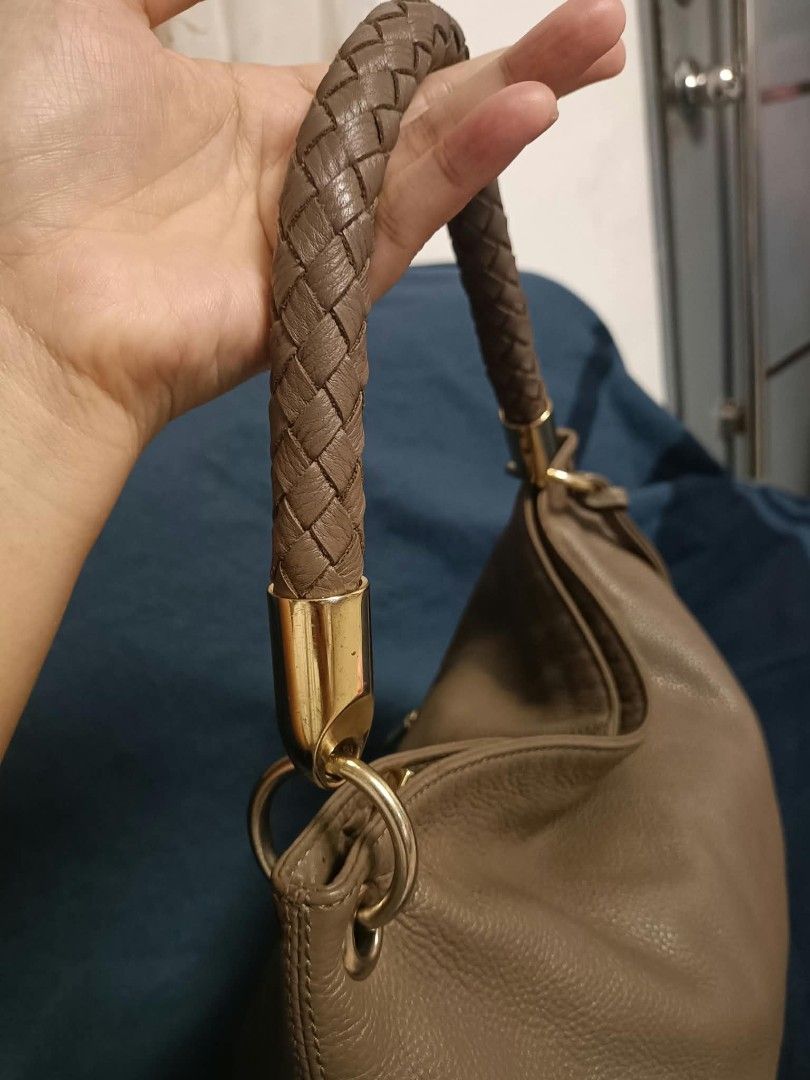 Pierre Cardin Paris hobo shoulder bag (Category: Shoulder Bags) located in Manila. Submitted by reneemaygo42069 (Listing ID 1466882143, Image 3). Description: - Color: Taupe - Material: Soft leather - Handle: Single braided handle in matching brown - Design: Intricate woven leather pattern on the lower section - Hardware: Gold-tone with a chic dangling circular charm - Interior: Spacious main compartment - Style: Slouchy hobo shoulder bag, great 