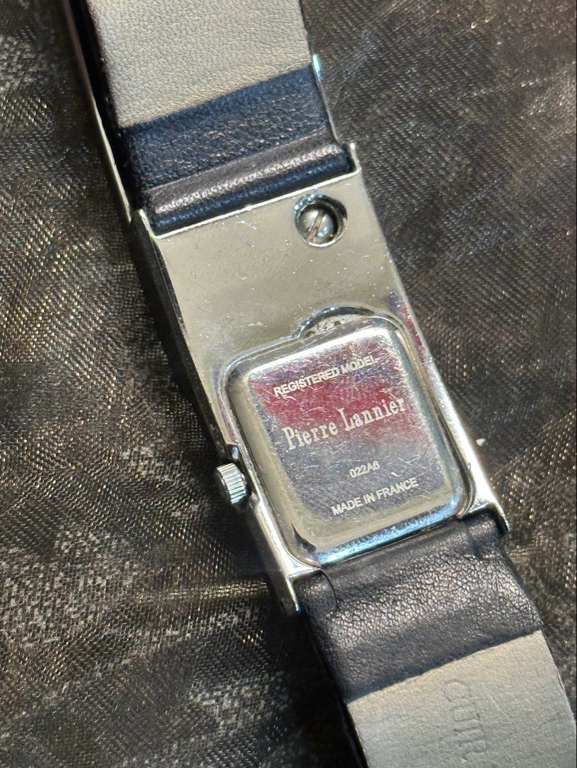 Pierre Lannier 022A6 Women's Rectangular Watch (Category: Women's Watches) located in Manila. Submitted by tenshiii185 (Listing ID 1466902511, Image 3). Description: - Brand: Pierre Lannier (Made in France) - Model: 022A6 - Design: Chic rectangular silver-tone case with a dark dial - Accents: Unique linked design with sparkling small crystals on the upper section - Markers: Simple dial markers at 3, 6, 9, and 12 o'clock - Strap: Classic black lea