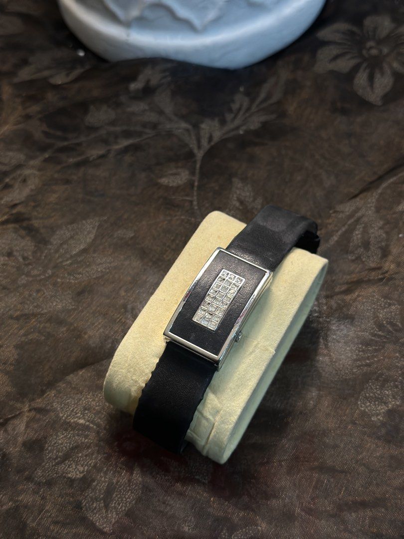 Pierre Lannier 022A6 Women's Rectangular Watch (Category: Women's Watches) located in Manila. Submitted by tenshiii185 (Listing ID 1466902511, Image 2). Description: - Brand: Pierre Lannier (Made in France) - Model: 022A6 - Design: Chic rectangular silver-tone case with a dark dial - Accents: Unique linked design with sparkling small crystals on the upper section - Markers: Simple dial markers at 3, 6, 9, and 12 o'clock - Strap: Classic black lea