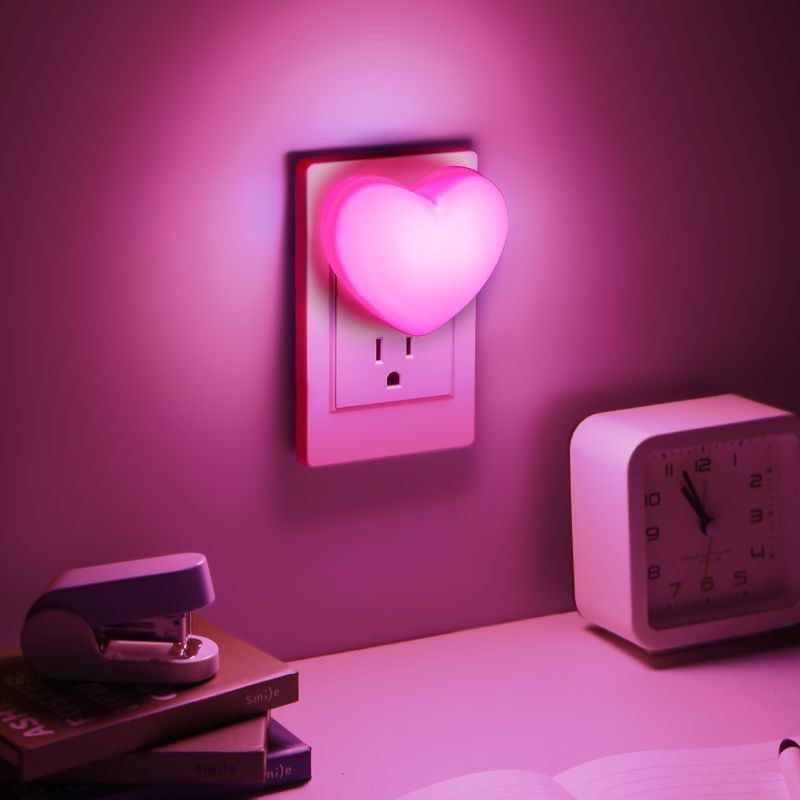 Pink Heart LED Plug-In Night Light (Category: Lighting) located in Taguig. Submitted by mengxir20193848 (Listing ID 1466812878, Image 2). Description: - Adorable heart-shaped design - Emits a gentle, relaxing soft pink glow - Convenient side switch for easy on/off control - Standard two-prong plug fits regular wall outlets - Compact and space-saving.