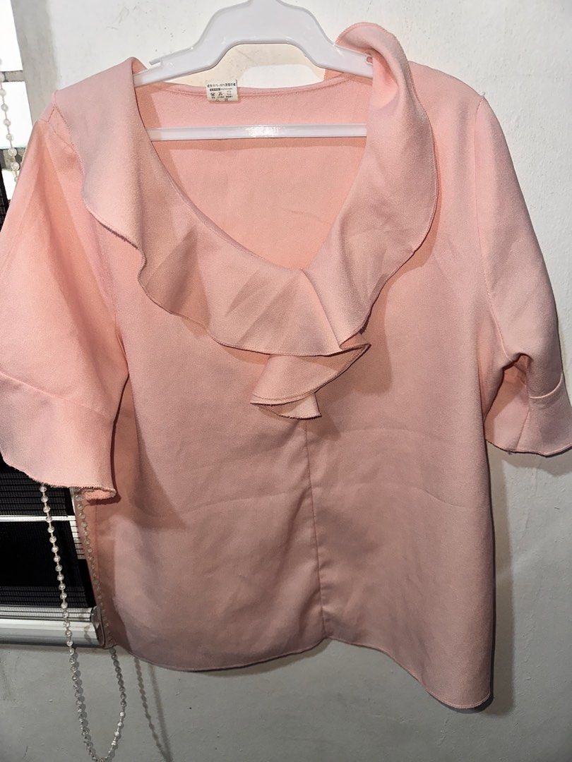 Pink Ruffle Collar Short Sleeve Blouse (Category: Blouses) located in Batangas. Submitted by egvdreamer (Listing ID 1466861841, Image 2). Description: - Color: Light Pink - Style: Relaxed fit V-neck blouse with a trendy wide ruffle collar - Sleeves: Short sleeves - Material: Soft textured fabric - Versatile: Great for casual daily wear or office outfits - Easy to style: Looks great with jeans, slacks, or skirts Sta rosa laguna.