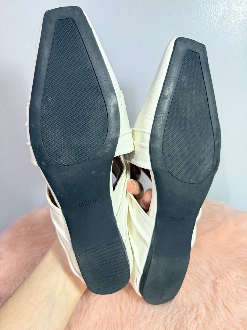 PIRA White Pointed Toe Mules Sliders Size 235 (6.5) (Category: Flats & Sandals) located in Quezon City. Submitted by shaberbree (Listing ID 1466916825, Image 3). Description: - Brand: PIRA - Style: Slip-on white mules with trendy pointed square toe and crossover strap design - Color: White with neutral tan insoles - Size: Marked 235 (US 6.5) - Condition: Minor wear on outsoles, tread is fully intact and ready to wear.
