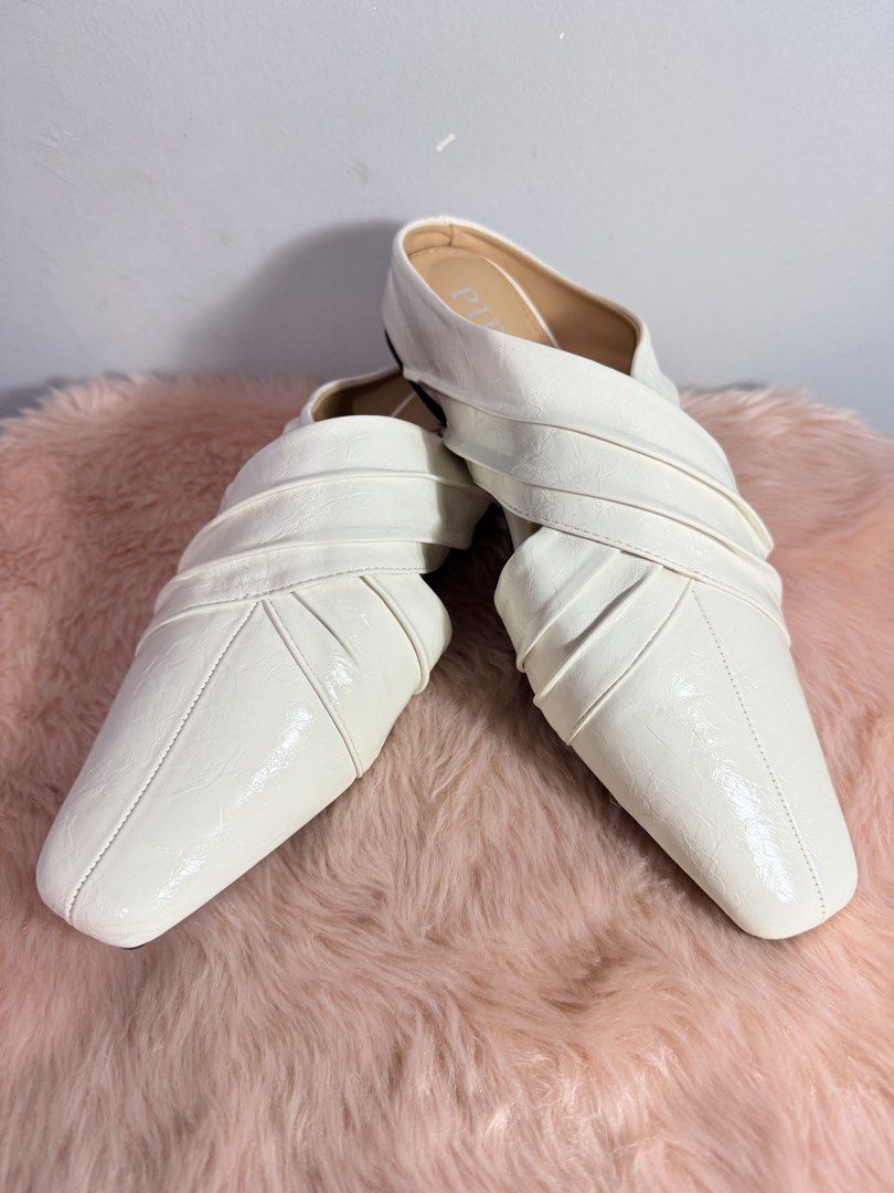 PIRA White Pointed Toe Mules Sliders Size 235 (6.5) (Category: Flats & Sandals) located in Quezon City. Submitted by shaberbree (Listing ID 1466916825, Image 2). Description: - Brand: PIRA - Style: Slip-on white mules with trendy pointed square toe and crossover strap design - Color: White with neutral tan insoles - Size: Marked 235 (US 6.5) - Condition: Minor wear on outsoles, tread is fully intact and ready to wear.