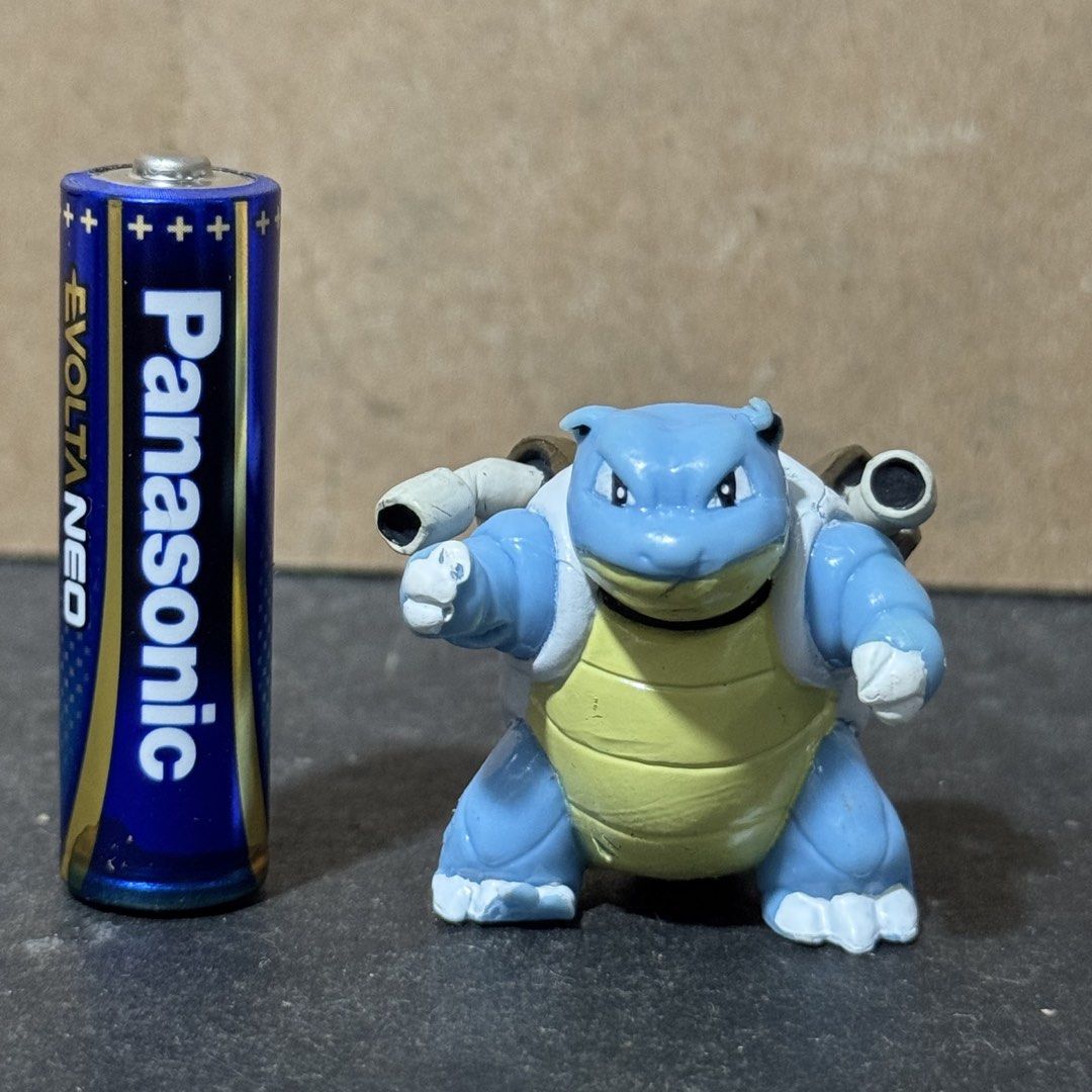 Pokemon Blastoise Mini Figure (Category: Figurines & Statues) located in Cuyapo. Submitted by blacksheepshop (Listing ID 1466787236, Image 1). Description: - Item: Genuine Pokémon Blastoise mini figure - Size: Stands about half the height of a standard AA battery - Details: Features molded shell cannons and official stamp on the back (Pokemon, B.China, 2656466 E) - Condition: Great compact collectible for display or gift - Shipping: Ships securel