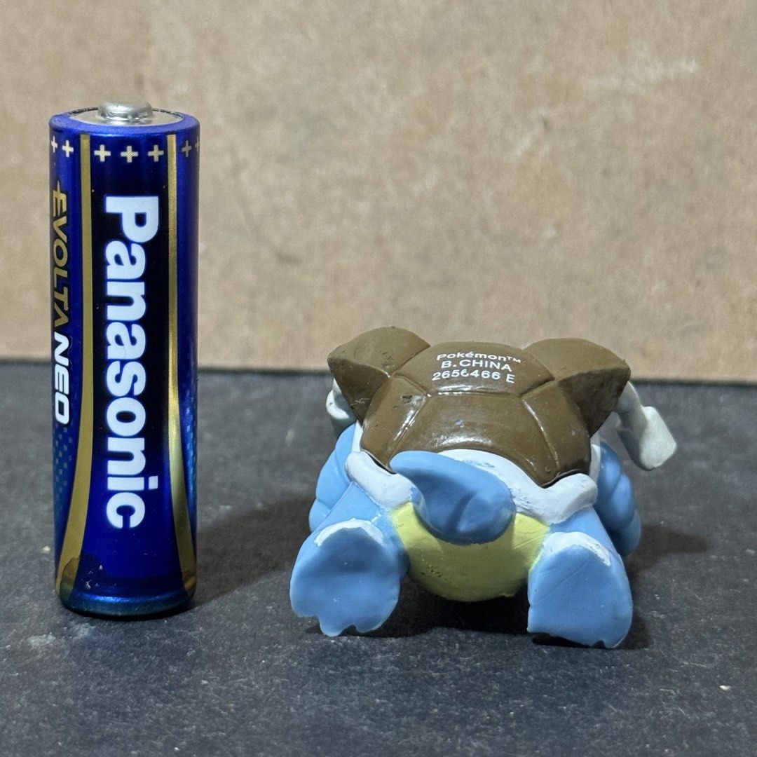 Pokemon Blastoise Mini Figure (Category: Figurines & Statues) located in Cuyapo. Submitted by blacksheepshop (Listing ID 1466787236, Image 3). Description: - Item: Genuine Pokémon Blastoise mini figure - Size: Stands about half the height of a standard AA battery - Details: Features molded shell cannons and official stamp on the back (Pokemon, B.China, 2656466 E) - Condition: Great compact collectible for display or gift - Shipping: Ships securel