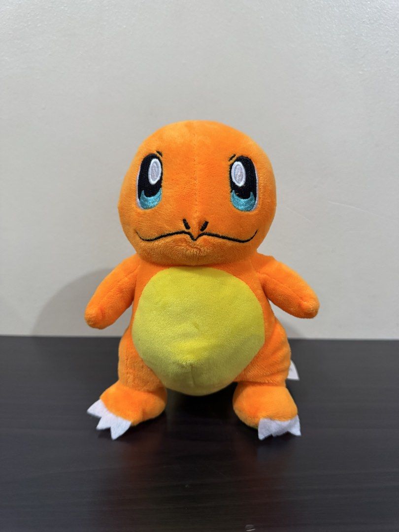 Pokemon Charmander Plush Toy (Category: Plushies & Soft Toys) located in Cainta. Submitted by mayhroeen (Listing ID 1466966386, Image 1). Description: - Item: Official Pokémon Charmander Plush - Condition: Like new, clean with no stains or damage - Details: Bright orange body, yellow belly, flame tail, embroidered blue eyes, and white claws - Authenticity: Official Pokémon tag still attached - Material: Ultra-soft plush fabric all over.