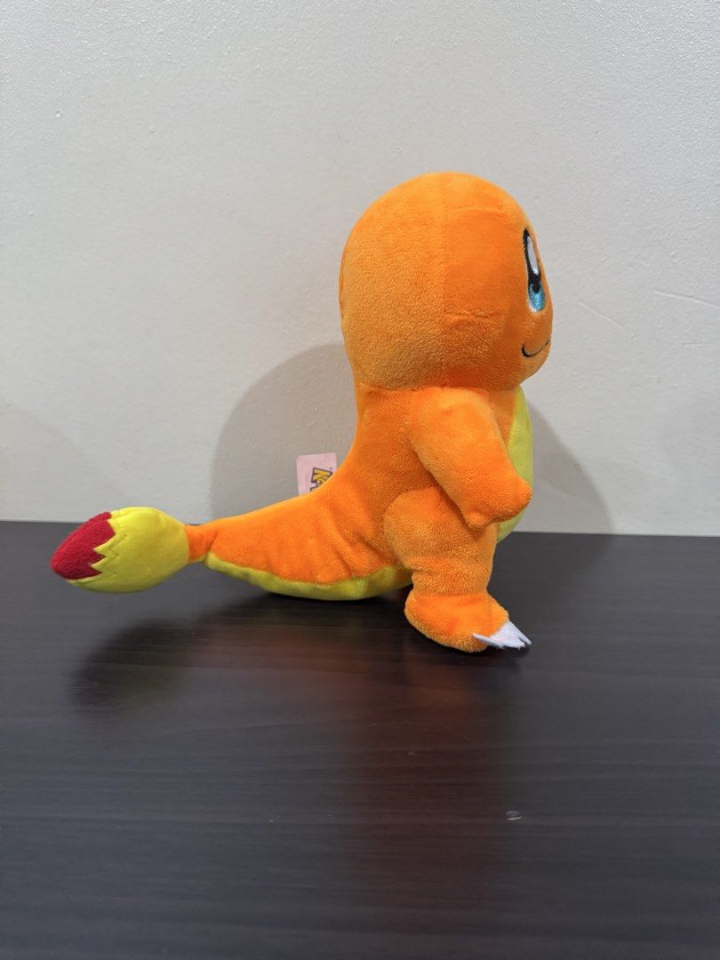 Pokemon Charmander Plush Toy (Category: Plushies & Soft Toys) located in Cainta. Submitted by mayhroeen (Listing ID 1466966386, Image 2). Description: - Item: Official Pokémon Charmander Plush - Condition: Like new, clean with no stains or damage - Details: Bright orange body, yellow belly, flame tail, embroidered blue eyes, and white claws - Authenticity: Official Pokémon tag still attached - Material: Ultra-soft plush fabric all over.