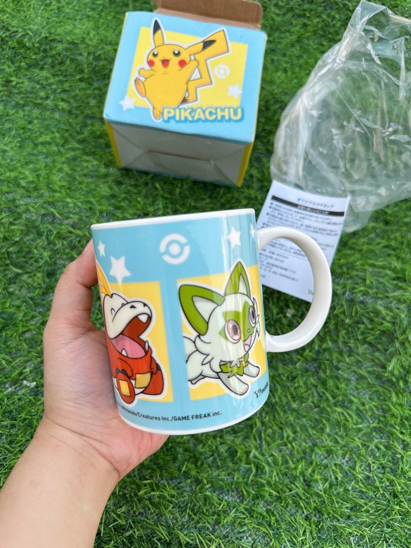 Pokémon Pikachu Sprigatito Fuecoco Quaxly Ceramic Mug (Category: Coffee & Tea Tableware) located in Manila. Submitted by ronoarabbit.ph (Listing ID 1466884892, Image 3). Description: - Pokémon ceramic mug with Pikachu, Sprigatito, Fuecoco, and Quaxly designs - Features a light blue background with white stars, Poké Ball graphics, and subtle SoftBank/Y!mobile logos near the base - Brand new and never used (only removed from packaging for photos) -