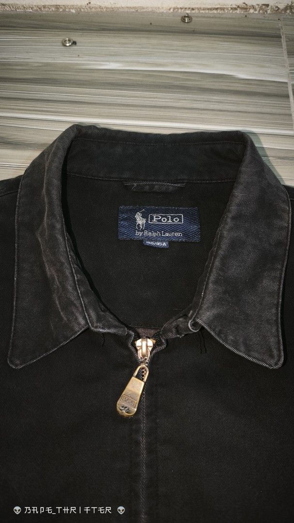 Polo by Ralph Lauren Black Zip Jacket (Category: Coats, Jackets and Outerwear) located in Lingayen. Submitted by c7quiter84444 (Listing ID 1466932718, Image 2). Description: - Brand: Polo by Ralph Lauren - Style: Classic black zip-up jacket - Size: 180/95A - Details: Pointed collar, custom branded metal zipper pull, subtle embroidered pony logo - Features: Buttoned cuffs, side hand pockets, and cool branded interior lining - Condition: Great vint