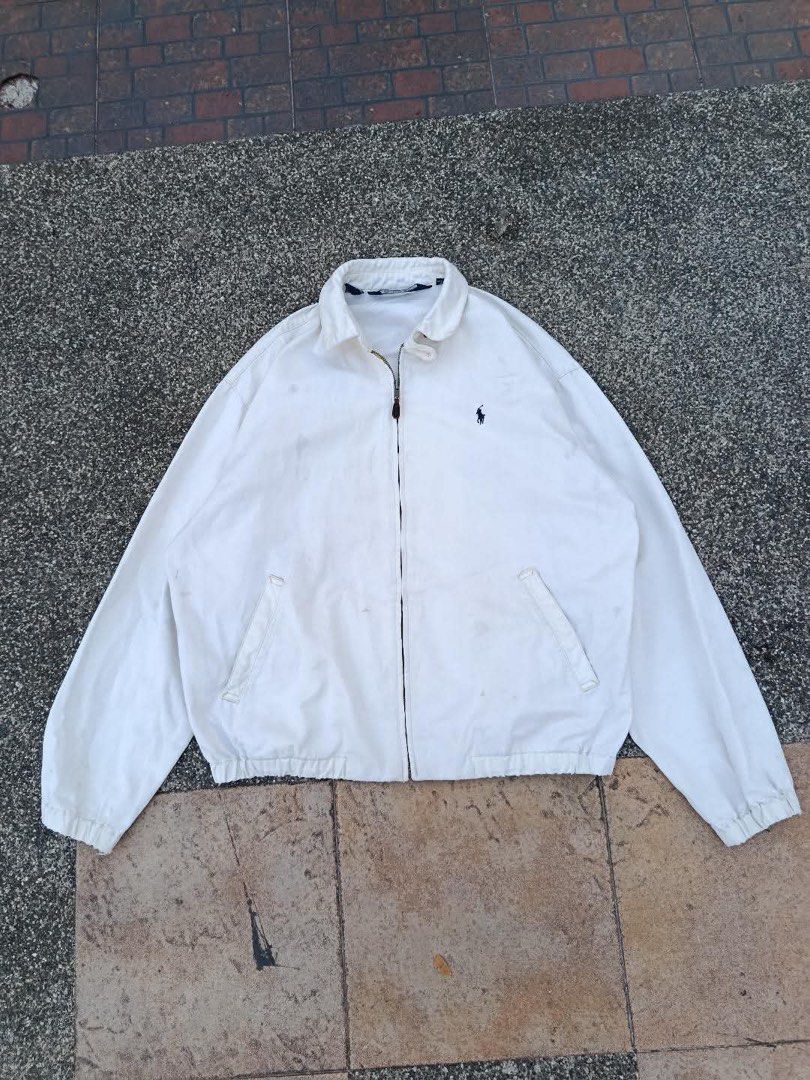 Polo by Ralph Lauren White Jacket (Category: Coats, Jackets and Outerwear) located in Manila. Submitted by luckyhorse.f804d6 (Listing ID 1466877613, Image 1). Description: - Brand: Polo by Ralph Lauren - Color: White with dark blue embroidered pony logo - Size: Medium (tag inside collar) - Material: 100% cotton (Made in Thailand) - Features: Full zip-up closure with leather pull, classic collar, front pockets, and elastic cuffs/hem - Condition: E