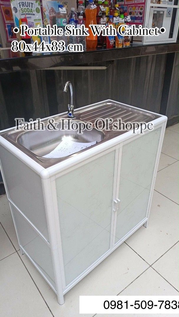 Portable Sink With Cabinet (Category: Bathroom & Kitchen Fixtures) located in Manila. Submitted by jamfrimzy089458 (Listing ID 1466830558, Image 1). Description: - Dimensions: 80 x 44 x 83 cm - Material: Durable white aluminium frame with patterned glass doors - Basin: High-quality stainless steel top with built-in drying tray and faucet included - Storage: Convenient built-in cabinet underneath - Ideal for: Outdoor kitchens, laundry utility area