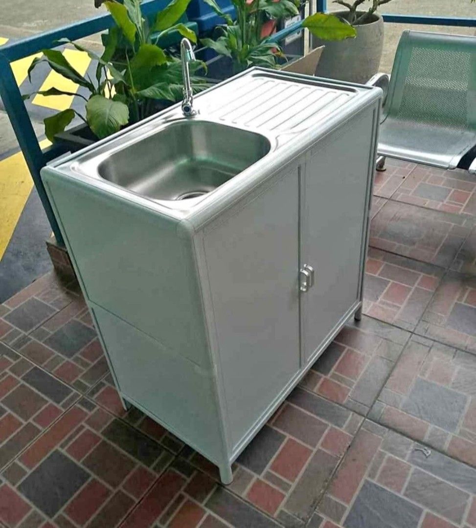 Portable Sink With Cabinet (Category: Bathroom & Kitchen Fixtures) located in Manila. Submitted by jamfrimzy089458 (Listing ID 1466830558, Image 2). Description: - Dimensions: 80 x 44 x 83 cm - Material: Durable white aluminium frame with patterned glass doors - Basin: High-quality stainless steel top with built-in drying tray and faucet included - Storage: Convenient built-in cabinet underneath - Ideal for: Outdoor kitchens, laundry utility area