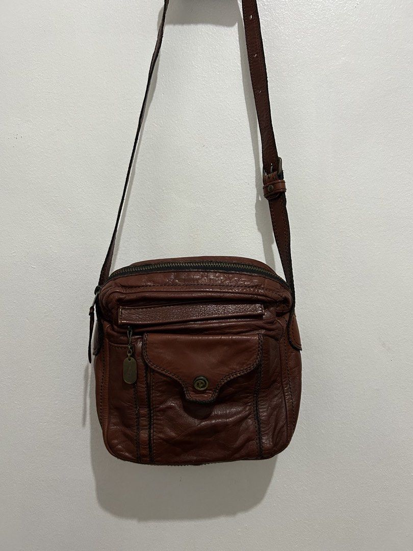 Porter Brown Leather Crossbody Bag (Category: Cross-body Bags) located in Angeles City. Submitted by cassey_phoenix (Listing ID 1466882740, Image 1). Description: - Brand: Porter - Material: Supple textured brown leather with contrast stitching - Strap: Adjustable shoulder strap with sturdy metal hardware - Storage: Multiple exterior zipper and flap pockets - Hardware: Brass-toned zipper pulls and YKK zippers throughout - Details: Signature Porte