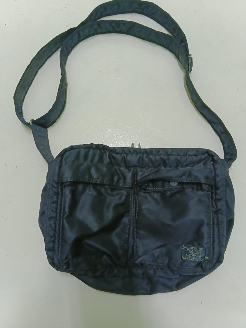 Porter Tanker Shoulder Bag Dark Navy (Category: Sling Bags) located in Manila. Submitted by daphnefinds (Listing ID 1466962255, Image 1). Description: - Authentic Porter Tanker messenger bag in dark navy nylon - Classic design featuring convenient front pockets with durable snap buttons - Secure zip closure for the main compartment - Comfortable, adjustable shoulder strap - Shows minor signs of wear on the fabric and woven label - Perfect, reliab