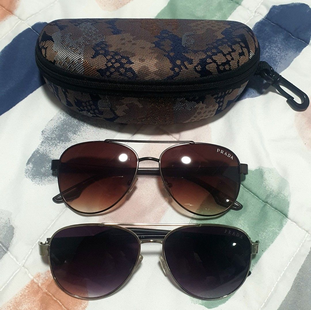 2-in-1 Prada Aviator Sunglasses with Case (Category: Sunglasses & Eyewear) located in Quezon City. Submitted by candicedng21 (Listing ID 1466905654, Image 1). Description: - 2 pairs of authentic Prada aviator sunglasses; can be bought 1-pair but no original casing, I can give a regular pouch or casing if you only buy one; without casing is cheaper: - Pair 1: Brown gradient lenses with dark frames; - Pair 2: Dark purple lenses with metallic frames