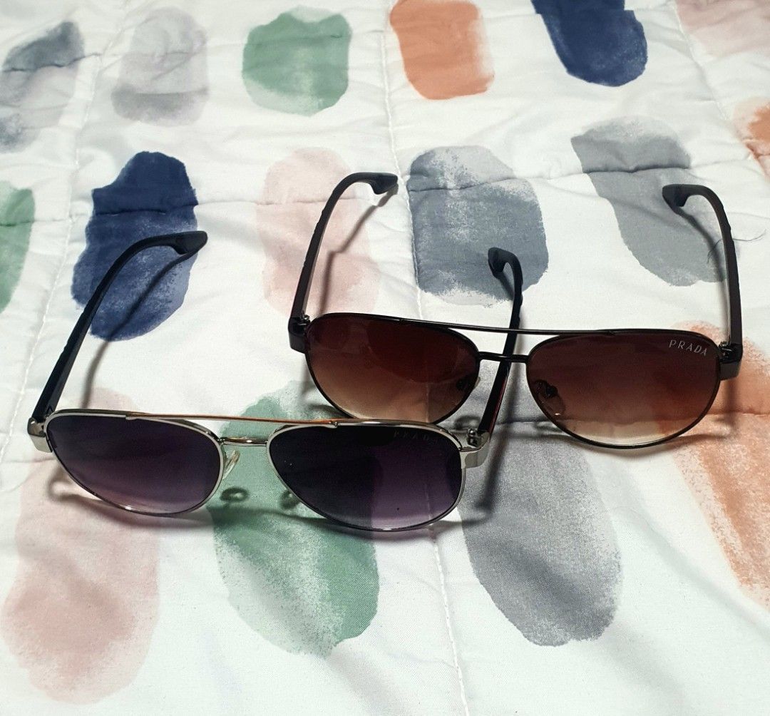2-in-1 Prada Aviator Sunglasses with Case (Category: Sunglasses & Eyewear) located in Quezon City. Submitted by candicedng21 (Listing ID 1466905654, Image 2). Description: - 2 pairs of authentic Prada aviator sunglasses; can be bought 1-pair but no original casing, I can give a regular pouch or casing if you only buy one; without casing is cheaper: - Pair 1: Brown gradient lenses with dark frames; - Pair 2: Dark purple lenses with metallic frames