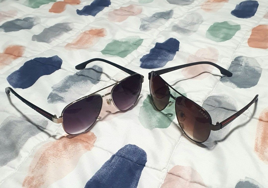 2-in-1 Prada Aviator Sunglasses with Case (Category: Sunglasses & Eyewear) located in Quezon City. Submitted by candicedng21 (Listing ID 1466905654, Image 3). Description: - 2 pairs of authentic Prada aviator sunglasses; can be bought 1-pair but no original casing, I can give a regular pouch or casing if you only buy one; without casing is cheaper: - Pair 1: Brown gradient lenses with dark frames; - Pair 2: Dark purple lenses with metallic frames
