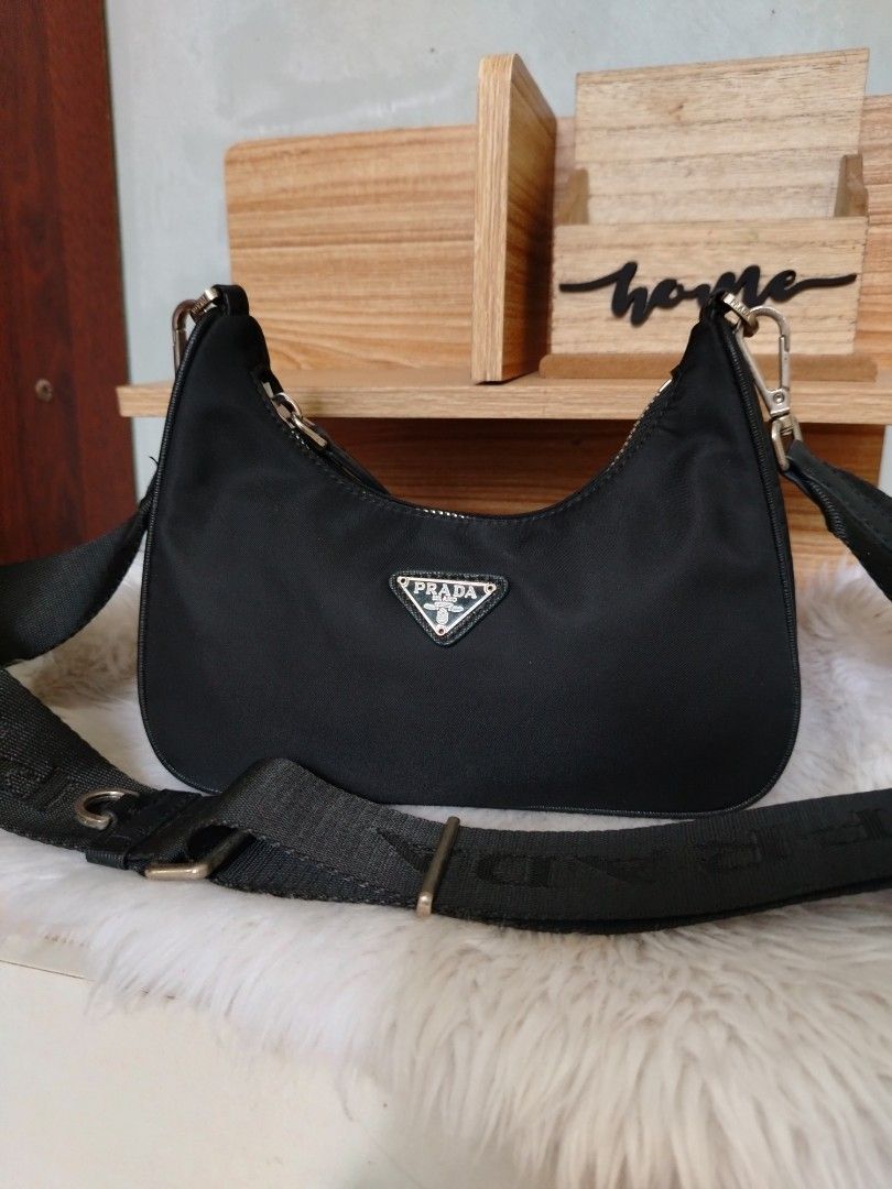 Prada Black Nylon Crossbody Shoulder Bag (Category: Luxury Bags & Wallets) located in Lucena. Submitted by gracious_chin0436 (Listing ID 1466793369, Image 1). Description: - Features the iconic triangular logo plaque on the front - Adjustable branded webbing strap with silver-toned hardware and clasp closures - Secure zip top closure for daily essentials - Clean edges and neat stitching throughout - Compact size, perfect for everyday casual or sm