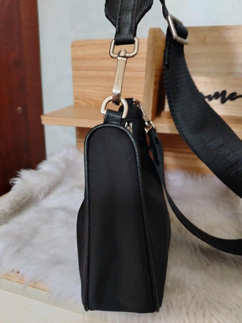 Prada Black Nylon Crossbody Shoulder Bag (Category: Luxury Bags & Wallets) located in Lucena. Submitted by gracious_chin0436 (Listing ID 1466793369, Image 3). Description: - Features the iconic triangular logo plaque on the front - Adjustable branded webbing strap with silver-toned hardware and clasp closures - Secure zip top closure for daily essentials - Clean edges and neat stitching throughout - Compact size, perfect for everyday casual or sm