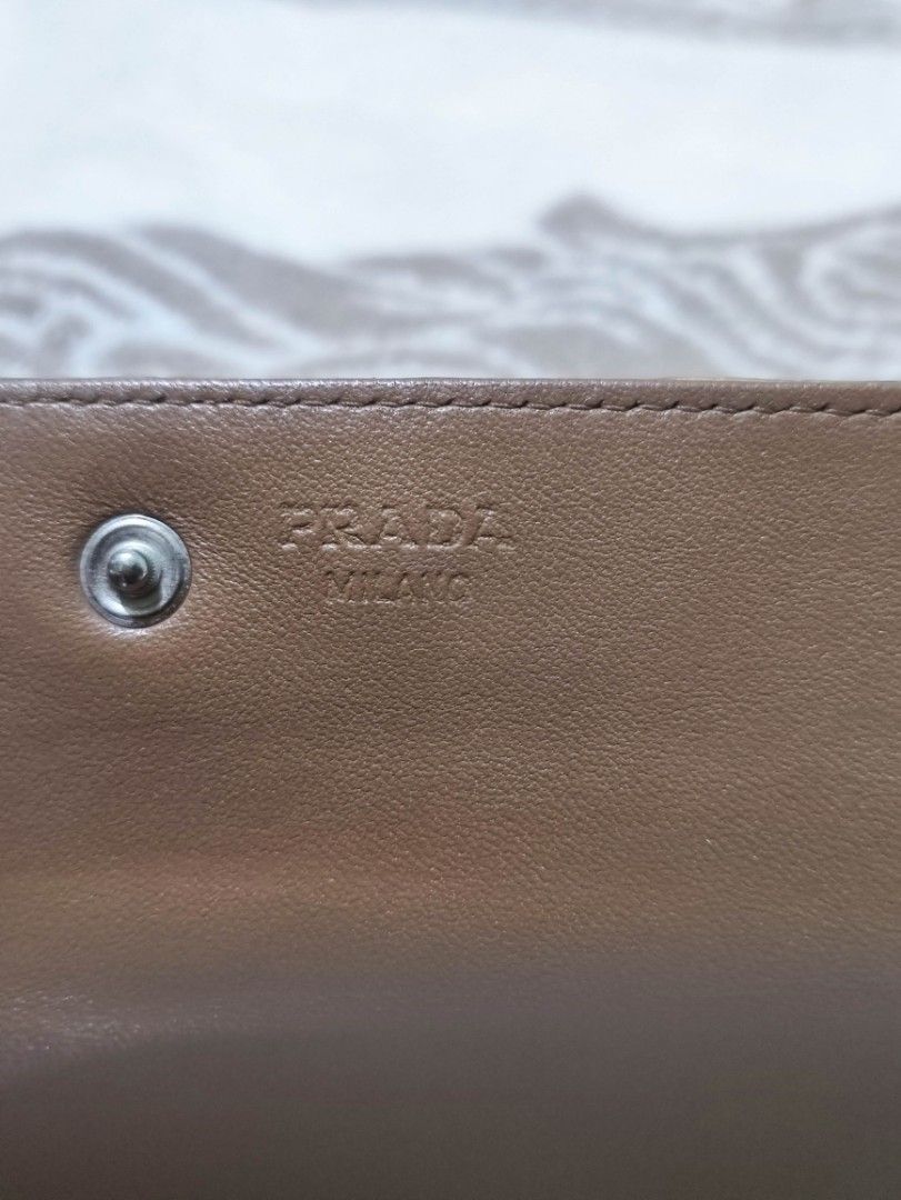Prada Crocodile Embossed Leather Long Wallet with Authenticity Card (Category: Wallets & Card holders) located in Manila. Submitted by chingmabut07171 (Listing ID 1466607175, Image 2). Description: - Authentic Prada long wallet in rich tan crocodile-embossed leather - Secure bi-fold closure style - Includes original authenticity card and dark blue envelope holder - Spacious interior fits cards, cash, and receipts easily - Classic luxury piece per