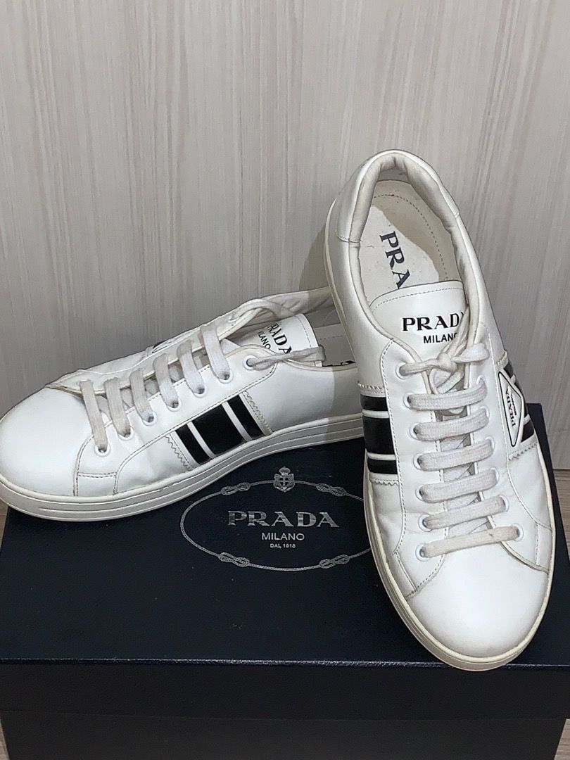 Prada Leather Sneakers White Black with Original Box (Category: Sneakers) located in Caloocan City. Submitted by christian_07deo (Listing ID 1466910781, Image 1). Description: - Authentic Prada white leather sneakers - Features stylish black side stripes and iconic triangle logo - Clean white leather upper with matching laces - Durable rubber sole for everyday wear - Includes original black Prada branded shoebox - Great luxury staple for your dai