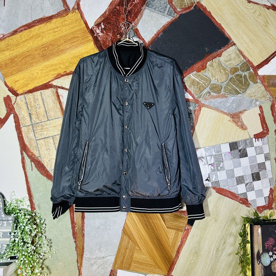 Prada reversible bomber jacket (Category: Luxury Apparel) located in Baguio. Submitted by kckc_luxury (Listing ID 1466907830, Image 2). Description: 🌸 TINY PINK SPOTS ARE LENS DAMAGE, NOT CLOTH STAINS ————————— ❗️KINDLY READ BEFORE MAKING AN OFFER❗️ LISTING DETAILS size:Medium width x length (inches):22x26.5 condition: EXCELLENT --- MOP: Gcash / BPI MOD: J&T / JRS LOCATION: Baguio City --- NOTE: • Manage your expectations • Photos did not go und