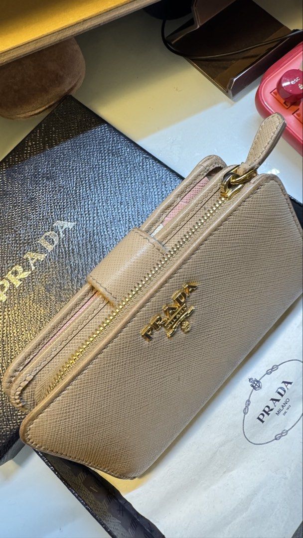 Prada Saffiano Leather Compact Wallet in Cammeo Multicolor (Category: Luxury Bags & Wallets) located in Antipolo. Submitted by lala.lysa (Listing ID 1466957249, Image 2). Description: Guaranteed authentic. - Brand: Prada - Material: Premium Saffiano leather - Hardware: Gold-tone with Prada Milano logo plate - Compartments: Card slots and secure zip coin pocket - Inclusions: Original black box, authenticity card - Condition: Well-maintained.