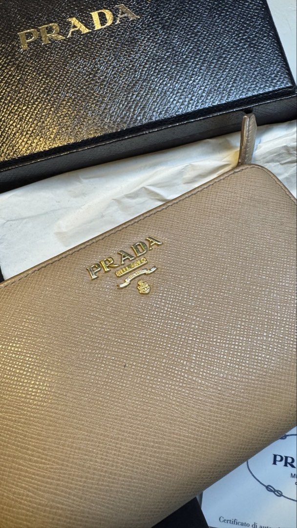 Prada Saffiano Leather Compact Wallet in Cammeo Multicolor (Category: Luxury Bags & Wallets) located in Antipolo. Submitted by lala.lysa (Listing ID 1466957249, Image 3). Description: Guaranteed authentic. - Brand: Prada - Material: Premium Saffiano leather - Hardware: Gold-tone with Prada Milano logo plate - Compartments: Card slots and secure zip coin pocket - Inclusions: Original black box, authenticity card - Condition: Well-maintained.