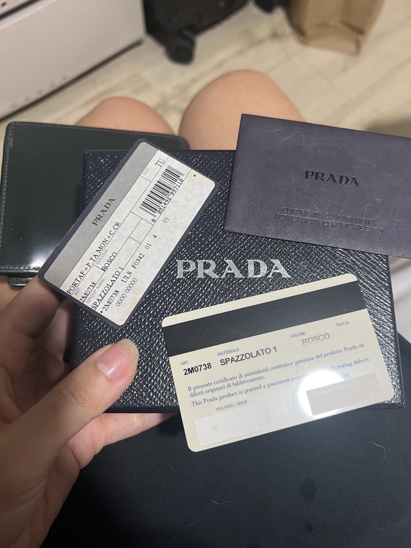 Prada Spazzolato Bi-Fold wallet (Category: Luxury Bags & Wallets) located in Angeles City. Submitted by pau.z (Listing ID 1466914201, Image 2). Description: Heavily used and the snap for the coin purse needs restitching. Scratches and corner scuffs as seen on photos. Authentic and complete with cards. Please manage your expectations..