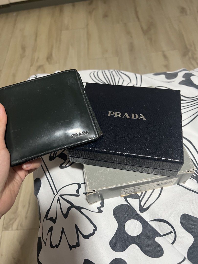 Prada Spazzolato Bi-Fold wallet (Category: Luxury Bags & Wallets) located in Angeles City. Submitted by pau.z (Listing ID 1466914201, Image 1). Description: Heavily used and the snap for the coin purse needs restitching. Scratches and corner scuffs as seen on photos. Authentic and complete with cards. Please manage your expectations..