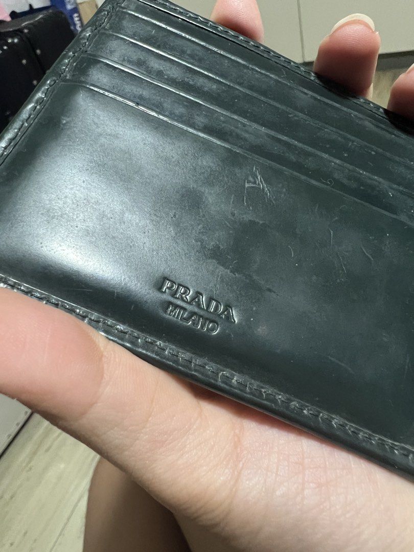 Prada Spazzolato Bi-Fold wallet (Category: Luxury Bags & Wallets) located in Angeles City. Submitted by pau.z (Listing ID 1466914201, Image 3). Description: Heavily used and the snap for the coin purse needs restitching. Scratches and corner scuffs as seen on photos. Authentic and complete with cards. Please manage your expectations..