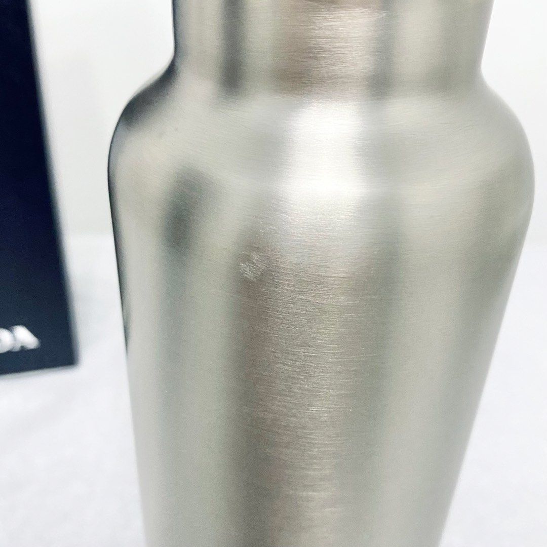Prada Stainless Water Bottle (Category: Water Bottles & Tumblers) located in Makati City. Submitted by aideclutter (Listing ID 1466811791, Image 2). Description: • Used only once • Bought in Prada Milan • Selling low due to some dents and scratches but these are barely noticeable (see photos) • With box • Can’t find the receipt anymore because I bought this with other Prada items • Buyer shoulders DF • Serious buyers only (please don’t waste my t
