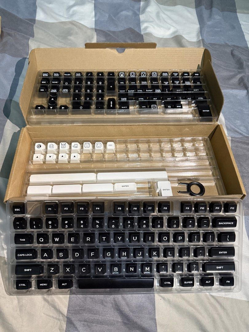 Preloved Keycaps (Category: Computer Keyboard) located in Manila. Submitted by Alyyy98 (Listing ID 1466895636, Image 1). Description: - Classic black and white aesthetic with unique novelty keys and accent pieces - Full compatibility for standard layouts and numpads - Includes a handy keycap puller tool for easy installation - Neatly organized in original plastic sorting trays and cardboard packaging - Excellent, clean condition - ready for your 