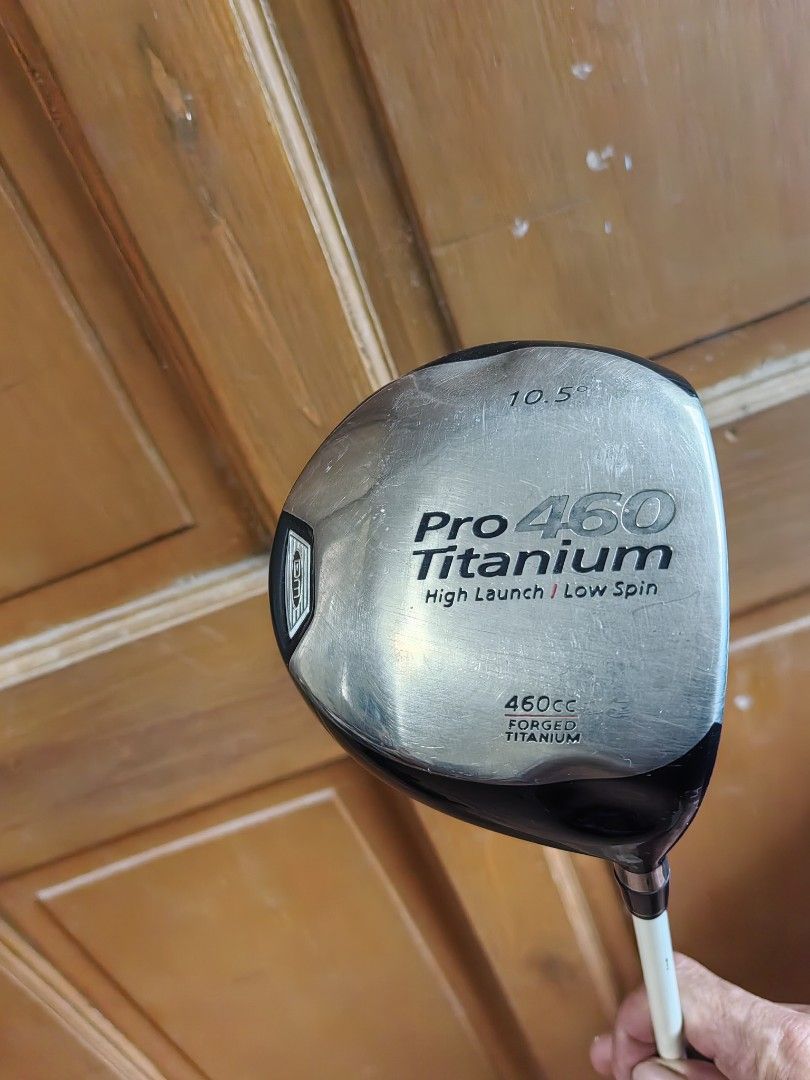 Pro 460 Titanium 10.5 Degree Golf Driver (Category: Golf) located in Silang. Submitted by jamessseller (Listing ID 1466918239, Image 3). Description: - Model: Pro 460 Titanium Driver - Loft: 10.5 degrees - Head Size: Large 460cc forged titanium head - Performance: High launch and low spin design for maximum distance - Shaft & Grip: Standard shaft with a stylish white grip section near the head - Condition: Normal wear and scratches on the metalli