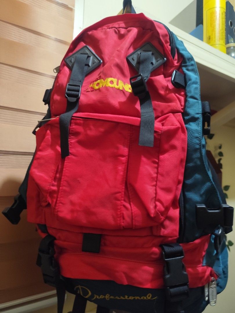 Professional Red and Green Hiking Backpack (Category: Backpacks) located in Naga. Submitted by semflewer (Listing ID 1466829771, Image 1). Description: - Color: Red and dark green with bold yellow lettering - Storage: Multi-compartment design with wide-opening main compartment and internal organization straps - Durability: Sturdy fabric construction built for heavy-duty use - Features: Adjustable straps, sturdy buckles, and exterior gear loops - 