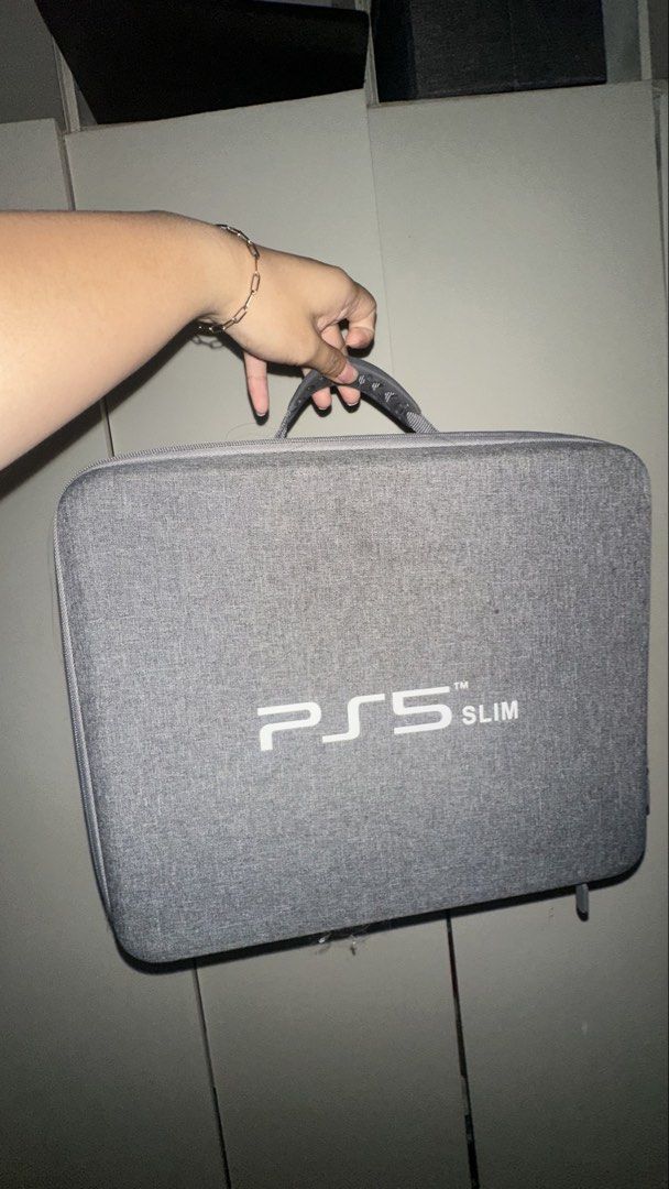 PS5 Slim Hard Shell Travel Case with Stand (Category: Cases & Covers) located in Las Pinas. Submitted by calizoosh (Listing ID 1466779486, Image 1). Description: PS5 SLIM HARD CASE: - grey - in pristine condition, all zippers are working - built-in straps inside to hold the console - will give a stand as well for the console RFS: Decluttering .