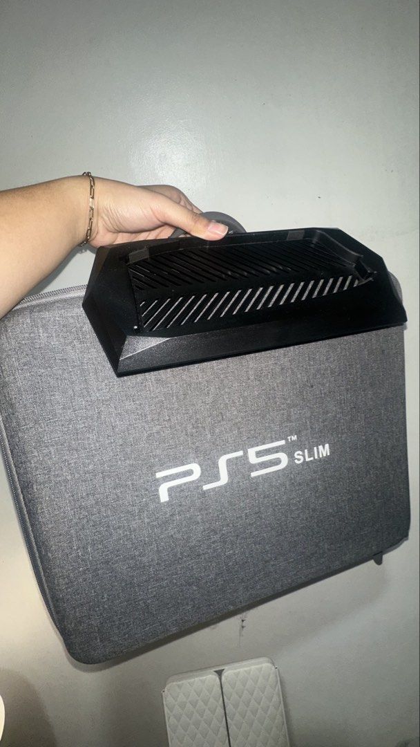 PS5 Slim Hard Shell Travel Case with Stand (Category: Cases & Covers) located in Las Pinas. Submitted by calizoosh (Listing ID 1466779486, Image 2). Description: PS5 SLIM HARD CASE: - grey - in pristine condition, all zippers are working - built-in straps inside to hold the console - will give a stand as well for the console RFS: Decluttering .