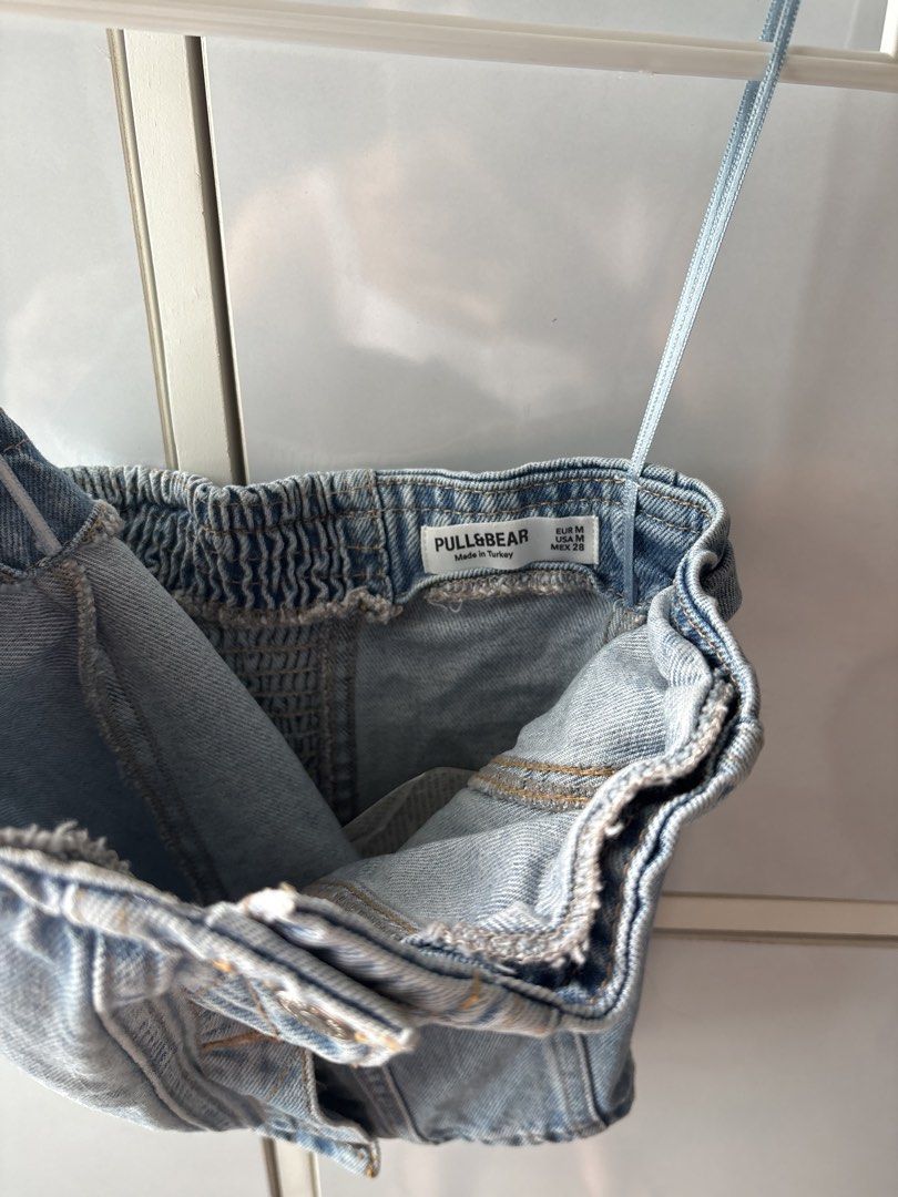 Pull&Bear Denim Corset Tube Top Size M (Category: Sleeveless) located in Manila. Submitted by jodi.declutters (Listing ID 1466783670, Image 2). Description: - Brand/Style: Pull&Bear denim tube top in light wash - Size: EUR M / USA M / MEX 28 FITS XS-S - Design: Spaghetti straps, metallic button-down front, and smocked elastic back panel - Origin: Made in Turkey - Vibe: Trendy Y2K piece, easy to pair with high-waisted jeans or skirts.