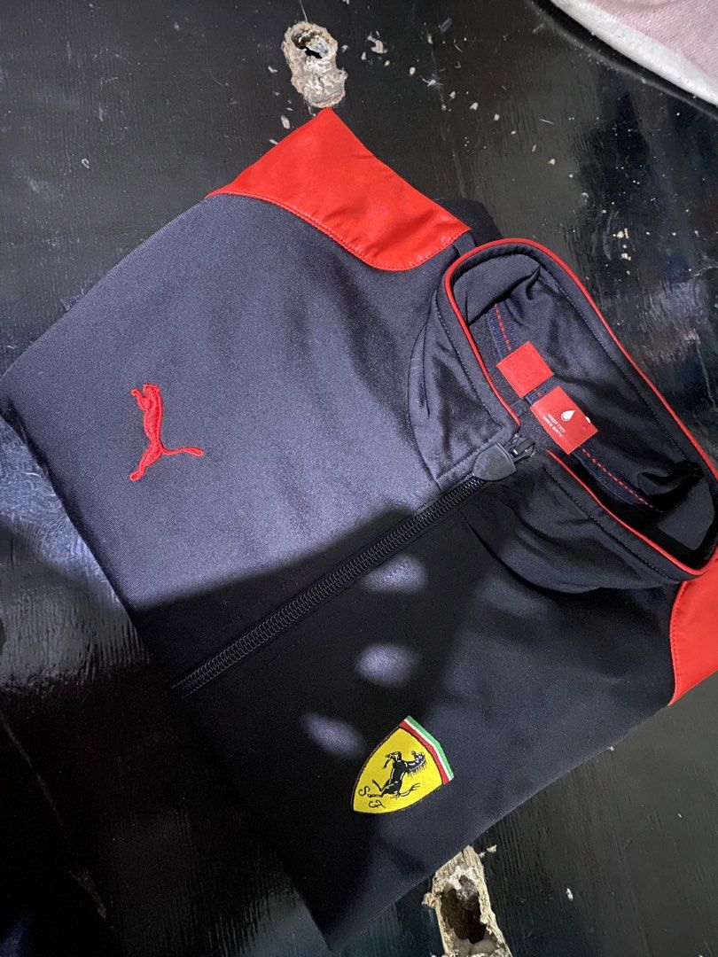 Puma Ferrari Track Jacket Black Red (Category: Coats, Jackets and Outerwear) located in Iligan City. Submitted by renzreyong66220 (Listing ID 1466897433, Image 3). Description: - Brand: Puma x Scuderia Ferrari - Color: Black with striking red panel details - Features: Full zip closure, stand-up collar, Ferrari shield badge, and embroidered Puma logo - Authenticity: Internal wash tags and official collaboration branding intact - Material: Lightwei