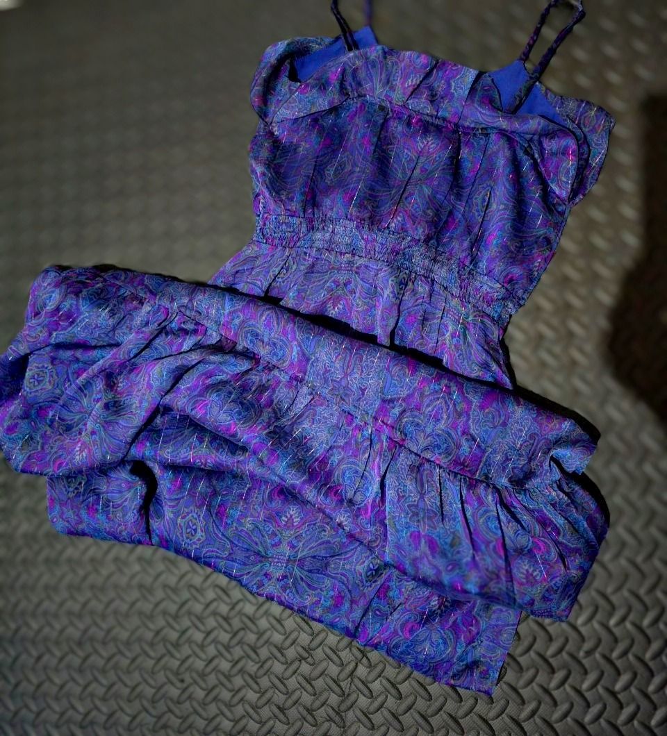 Purple Paisley Pattern Long Dress Size Small (Category: Dresses) located in Lapu Lapu. Submitted by goodstuff_cebu (Listing ID 1466949104, Image 3). Description: - Size: Small to medium - Design: Purple and blue paisley print with subtle shimmer thread - Details: Spaghetti straps, smocked elastic waist, and ruffled hem - Material: Flowy, lightweight fabric - Versatility: Perfect for warm weather or layering - Condition: Good as new (Ready to ship